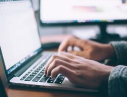 hands typing on a computer